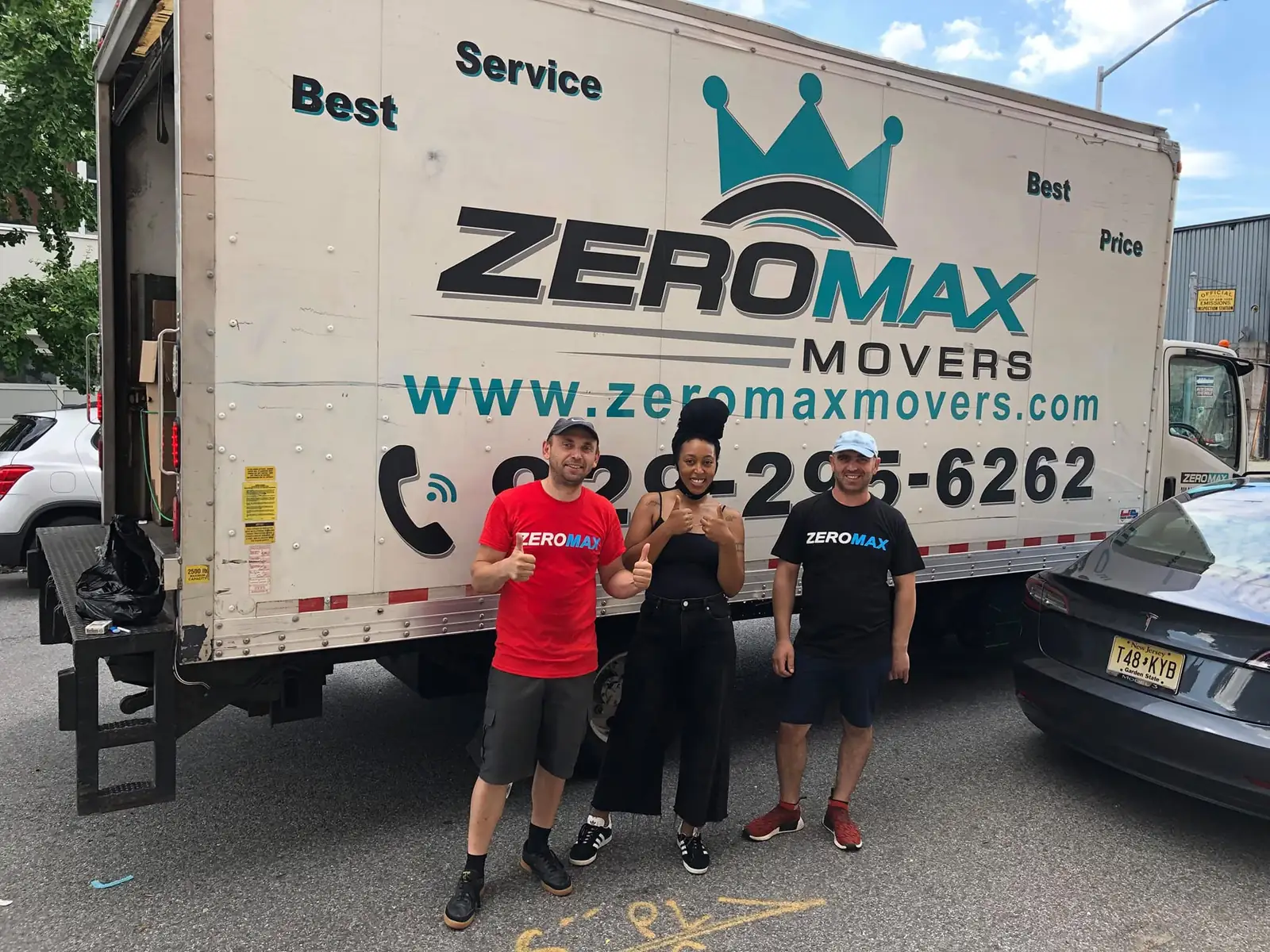 Happy customers with the ZeroMax Moving and Storage crew and truck