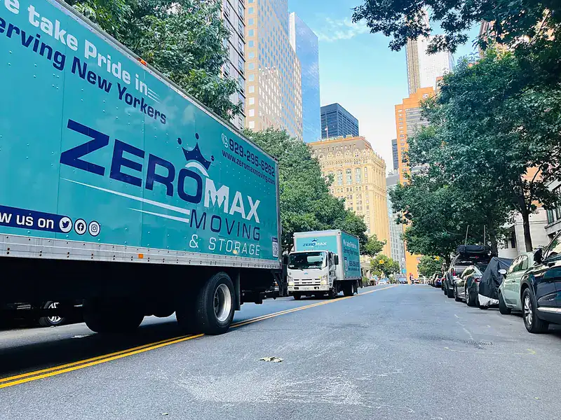 ZeroMax moving truck on a tree-lined street with the city skyline behind it for a move from NYC to Atlanta