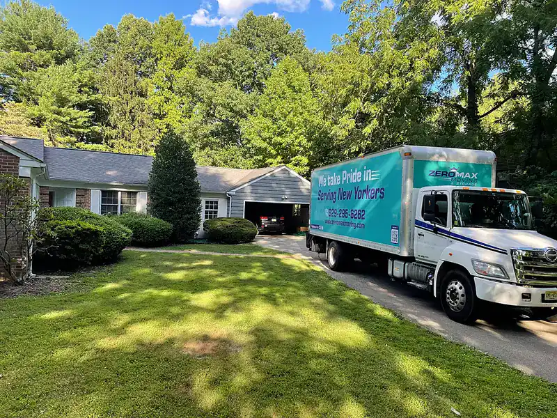 ZeroMax moving truck parked outside a suburban house for a move from NYC to Charlotte
