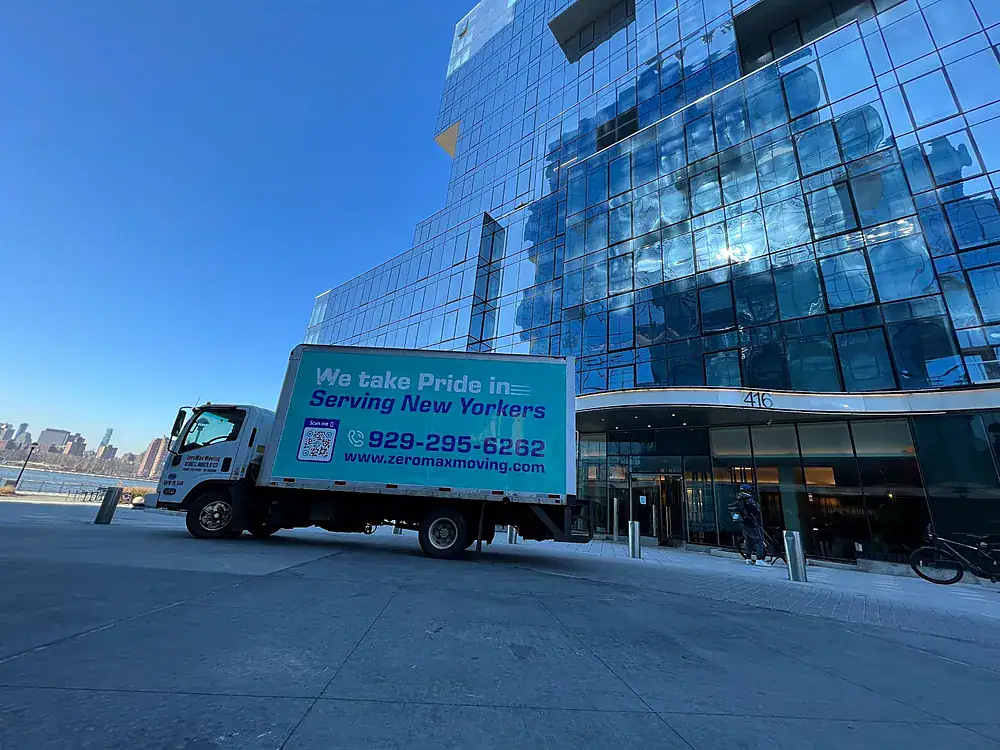 ZeroMax moving truck parked in front of a glass high-rise for a move from NYC to Chicago