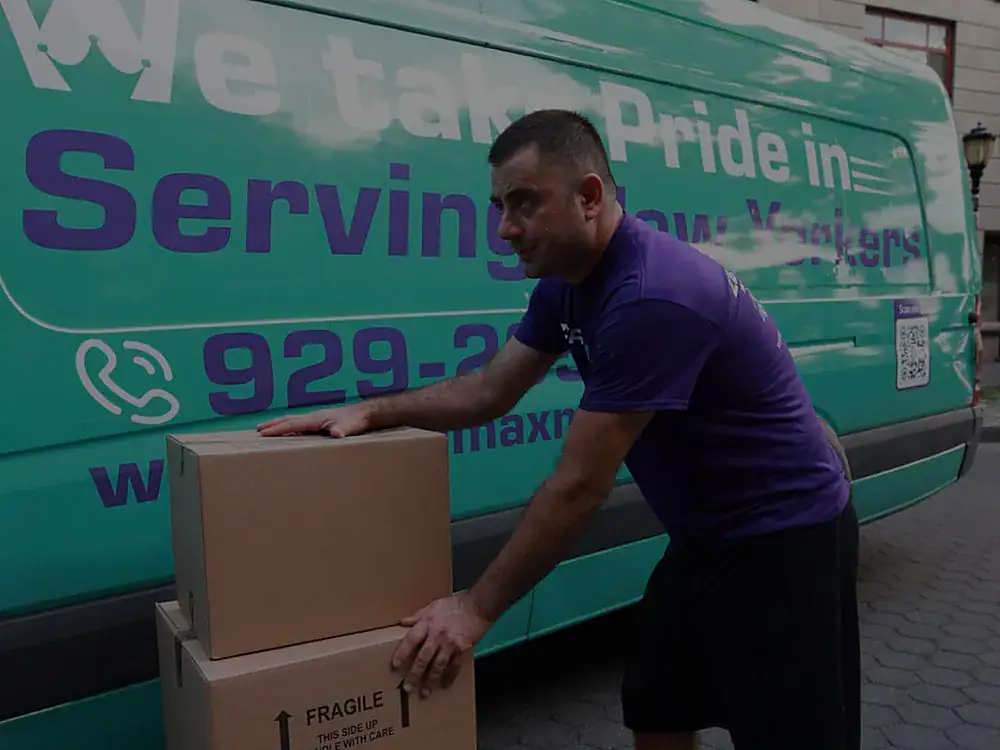 ZeroMax mover stacking boxes beside a moving van for a move from NYC to Dallas