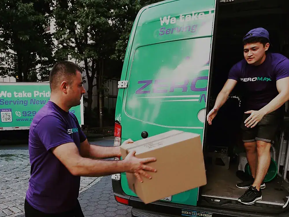 ZeroMax movers unloading a box from a moving van for a move from NYC to Houston