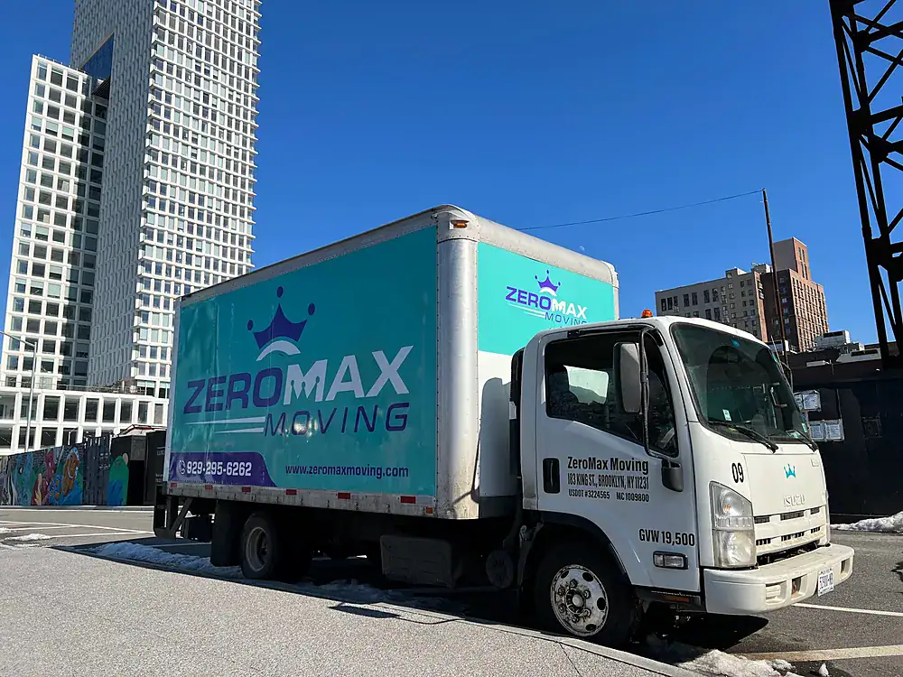 ZeroMax moving truck parked below a high-rise apartment tower for a move from NYC to Miami