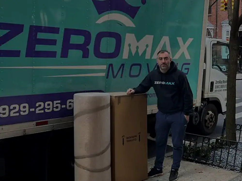 ZeroMax mover with packed items beside a branded moving truck for a move from NYC to Nashville